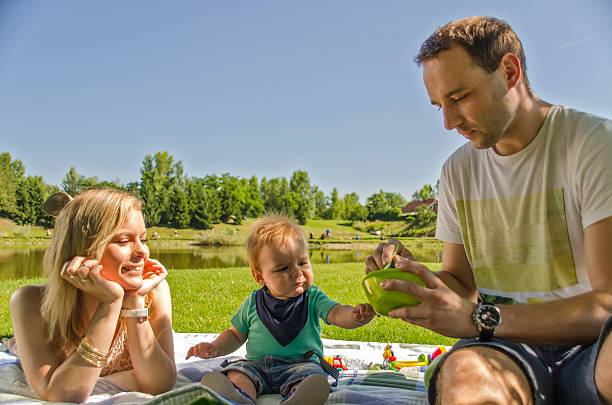 istock Feeding baby in the park 512360637