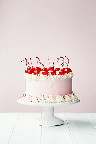 istock Cake decorated with maraschino cherries 512363657