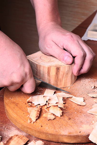 istock carpenter hand carving wood 512364511