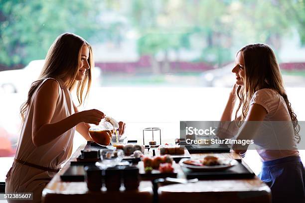 Taking The Time To Catch Up Stock Photo - Download Image Now - Pouring, Sister, Adult