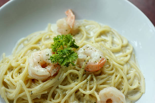 istock spaghetti with shrimp and white cream sauce. 512386493