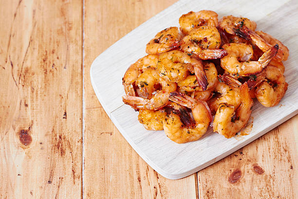 istock Grilled shrimps on wooden board 512388385
