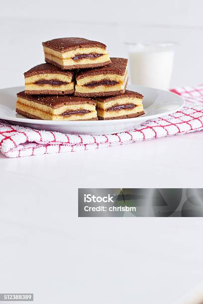 Chocolate Cream Cakes On White Plate With Glass Of Milk Stock Photo - Download Image Now