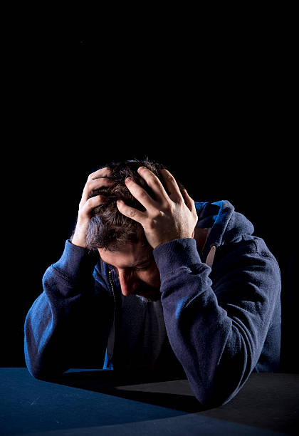 istock desperate man suffering emotional pain, grief and deep depression 512389949