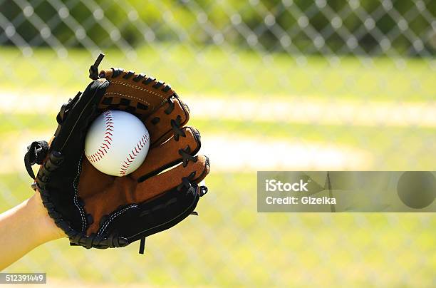 Hand Of Baseball Player With Glove And Ball Over Field Stock Photo - Download Image Now