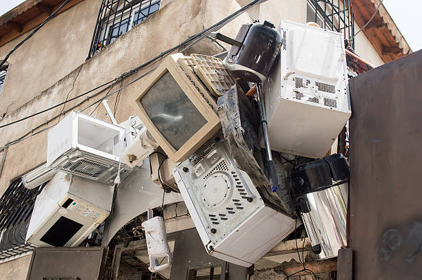 electronic equipment hanging on a wall Metal and plastic recycling the home electronic hanging on a wall of a house in jerusalem city dump radiator stock pictures, royalty-free photos & images