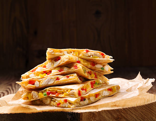 Quesadilla with chicken, served with guacamole or salsa sauce.