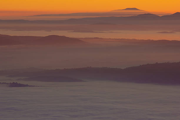 istock Umbria valley at sunset with fog. 512397080