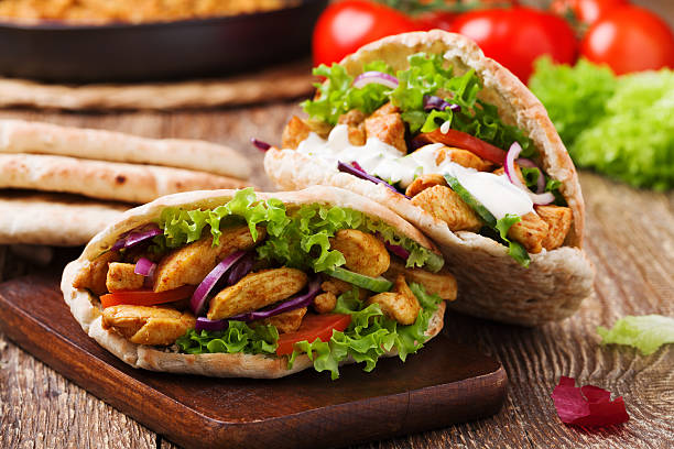 Roasted chicken and vegetables, served in pita. Pita salad with roasted chicken and vegetables, served with a delicious sauce kebab stock pictures, royalty-free photos & images