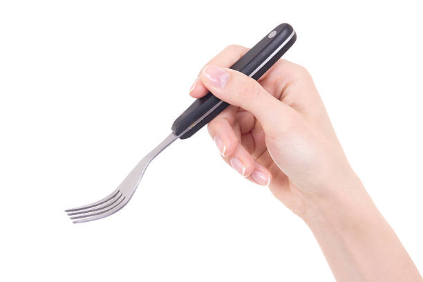 istock woman hand holding fork isolated on white 512401458