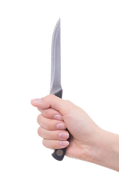 istock female hand holding knife isolated on white 512401538