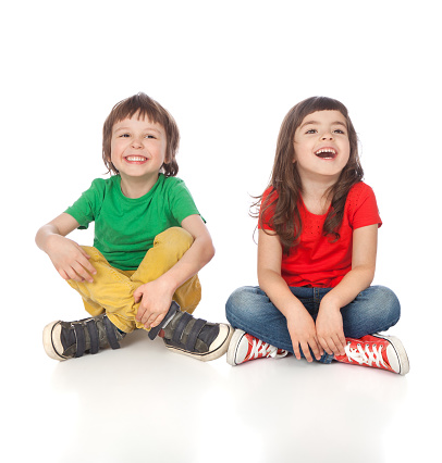 Adorable boy and girl having great time, isolated on white