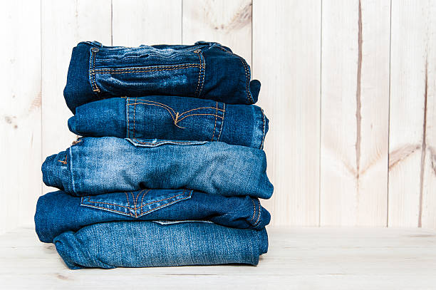 istock jeans stacked on a wooden background 512404220