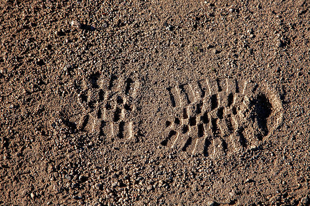 istock Shoe Boot Footprint Desert Soil 512404354