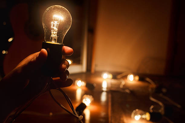 Incandescent light bulb, warm turned on. Garland of tungsten lamps stock photo