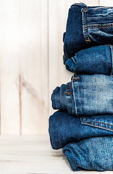 istock stack of various shades  blue jeans on wooden background 512404392