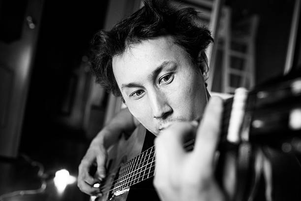 istock Crazy passionate guitarist playing guitar, black and white close-up 512407672
