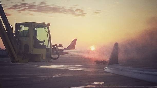 istock Winter De-ice Bucket Truck Spraying Airplanes Wing, Sunset 512409334