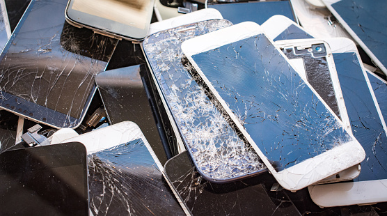 Stack of broken glass touch screens from smartphones