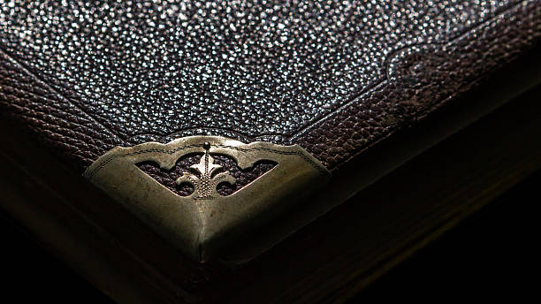 Old leather bound book with Fleur-de-lis on the corner stock photo