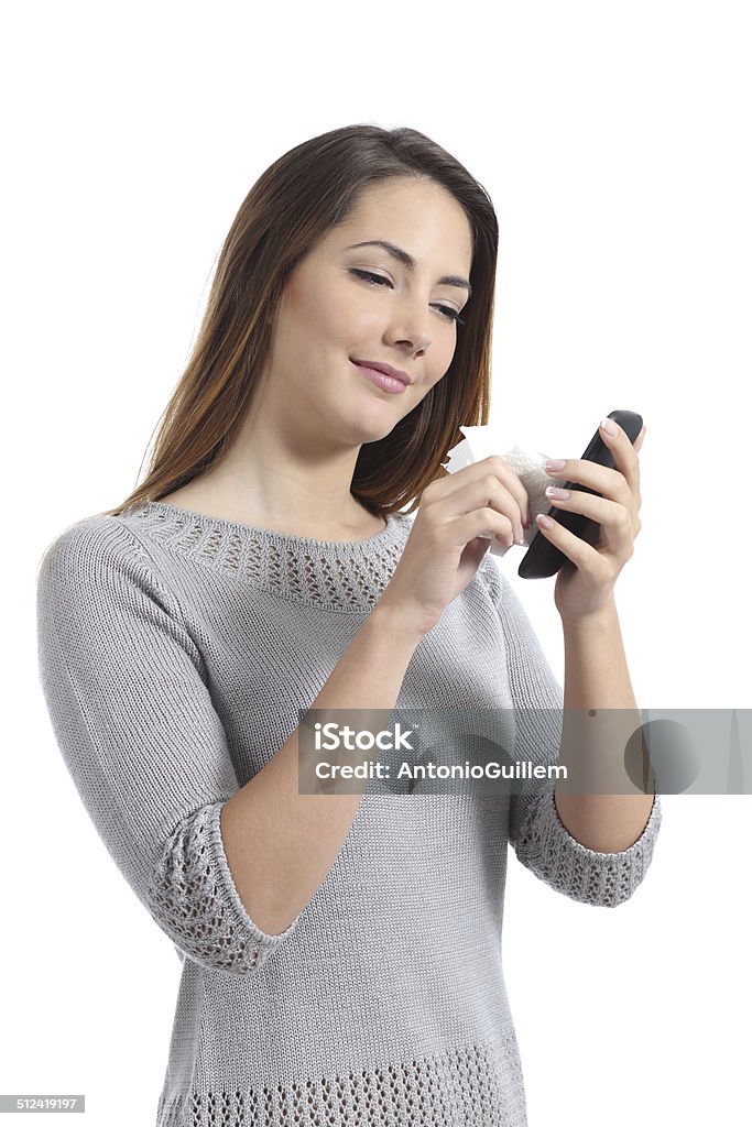 Pretty woman cleaning her smart phone screen Pretty woman cleaning her smart phone screen isolated on a white background Smart Phone Stock Photo