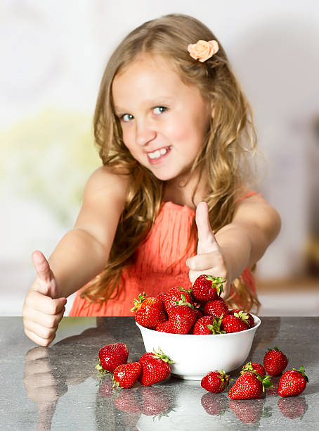 istock Little girl with strawberry 512419289
