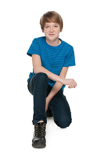 istock Preteen boy sits on the white background 512419369