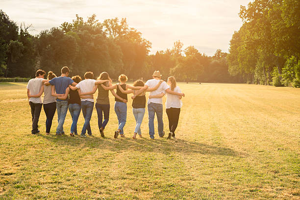 istock group of teenagers walking while holding together 512422611