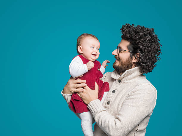 istock Father and daughter on blue background, Smiling portrait 512434456
