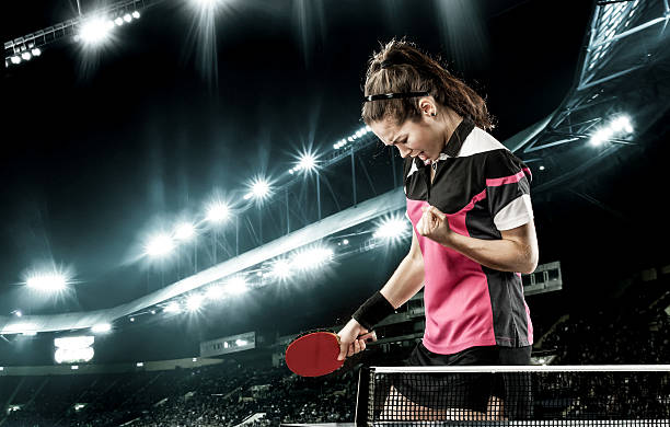 Young handsome woman celebrating flawless victory in table tennis stock photo