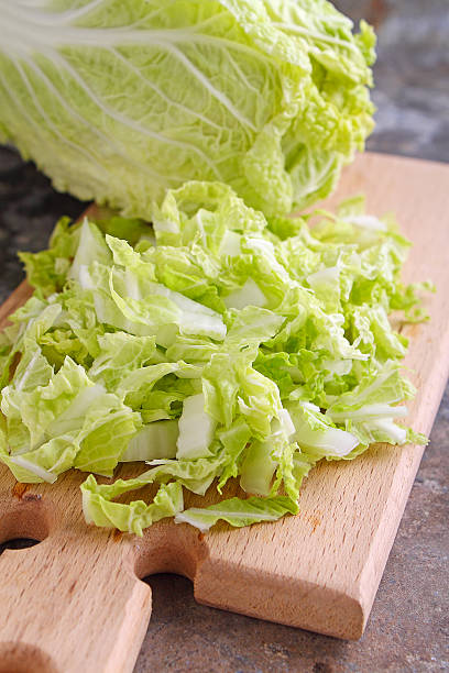 istock Chinese cabbage sliced on a wooden board 512435182