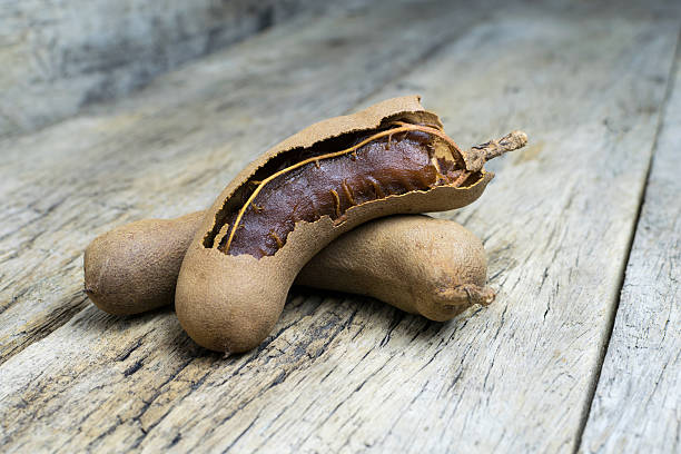 istock tamarind on grunge wooden background 512435778