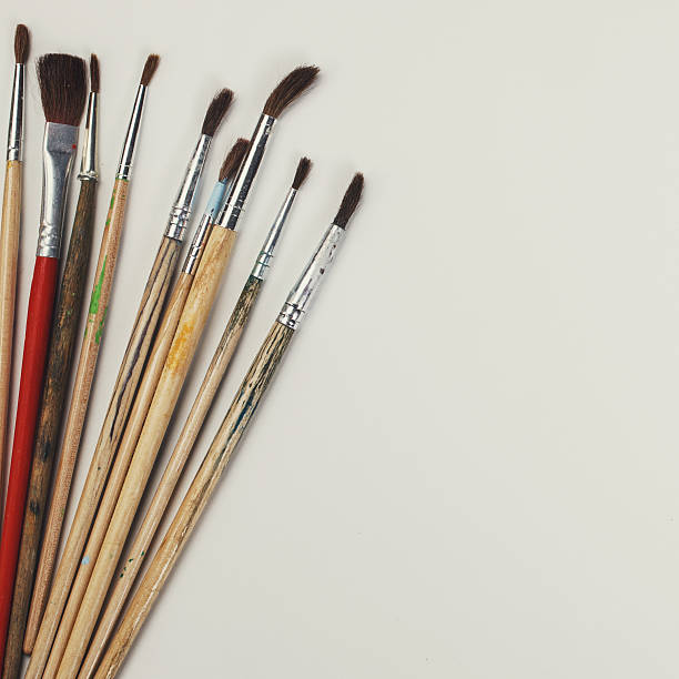 istock brushes for painting  and blank white paper sheet 512436136