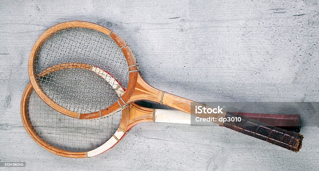 Two vintage rackets Two vintage tennis rackets on wooden background Wood - Material Stock Photo