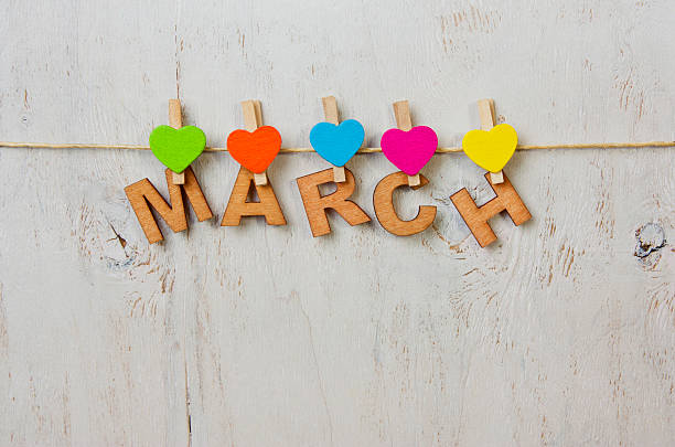 istock word March and multicolored hearts on a white background wooden 512438392