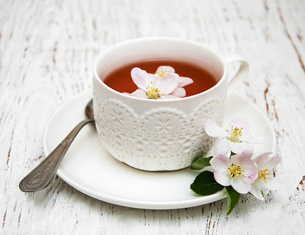 istock Cup of tea and spring apple blossom 512440446