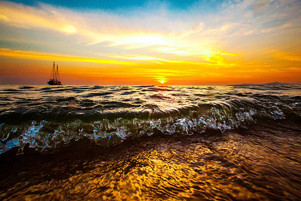 istock Drifting boat in the ocean on a sunset 512441170