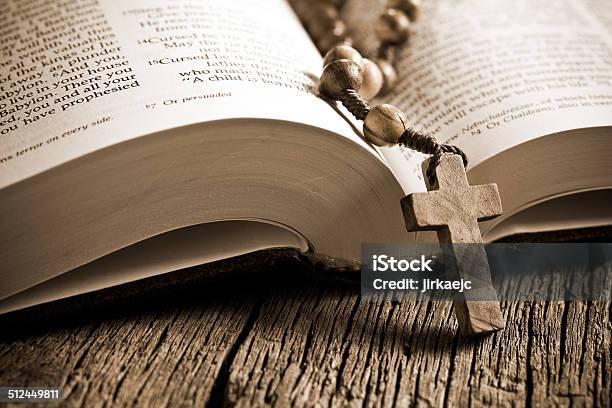 Wooden Rosary On The Open Bible Stock Photo - Download Image Now - Bible, Book, Brown