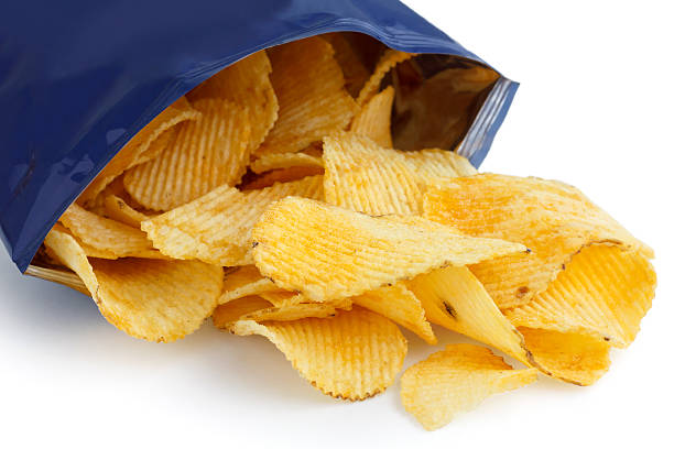 istock Crinkle cut crisps spilling out of a foil packet. 512452783