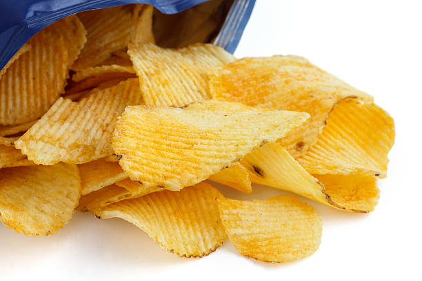 istock Crinkle cut crisps spilling out of a foil packet. 512452791