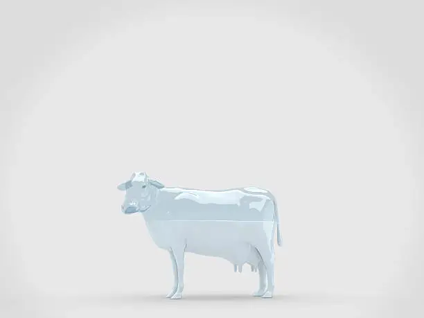 Glass cow with milk inside on light grey limbo background