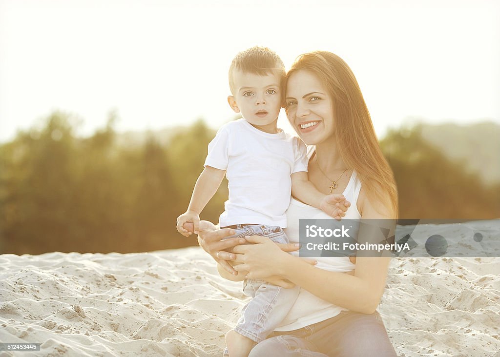 happy mother and son in the mountains playing Happy mother and son on the beach sunset Adult Stock Photo