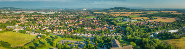 istock Suburban housing homes surrounded by green summer fields aerial panorama 512453931