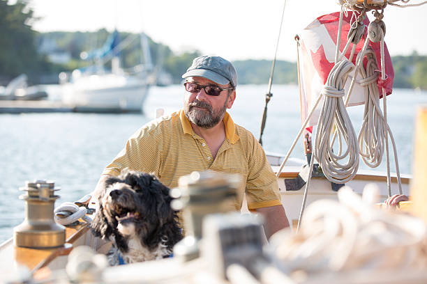 istock Man and his dog on a sailboat 512453945