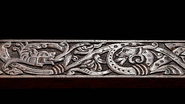 istock Viking wood carving depicting two fire breathing dragons fighting 512455501