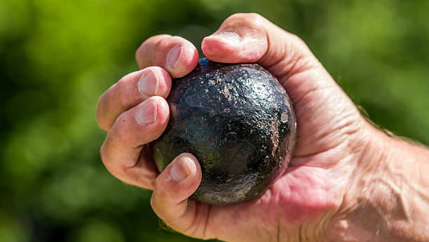 istock 4lb cannon ball in hand 512455523