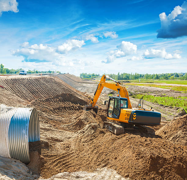 istock exkavator working on construction site near the road 512457946