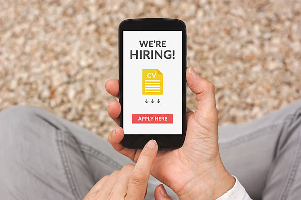 istock Hands holding smartphone with we are hiring concept on screen 512458016