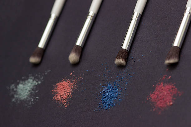 istock Crushed eye shadow and brush  isolated on black 512471938