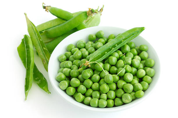 istock Fresh garden peas in a ceramic dish shot from above. 512473873